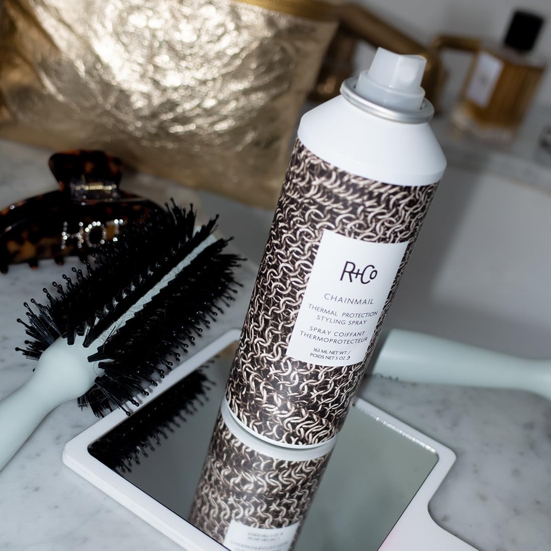 R+Co Chainmail texture on fingers highlighting non-greasy, silky finish