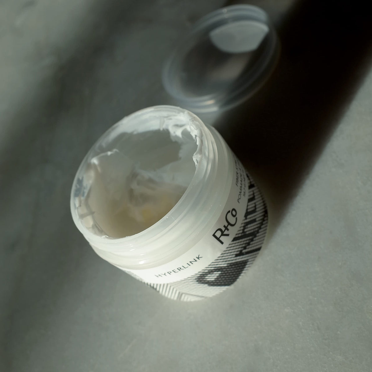 R+Co Hyperlink on styled short hair showing weightless volume and texture