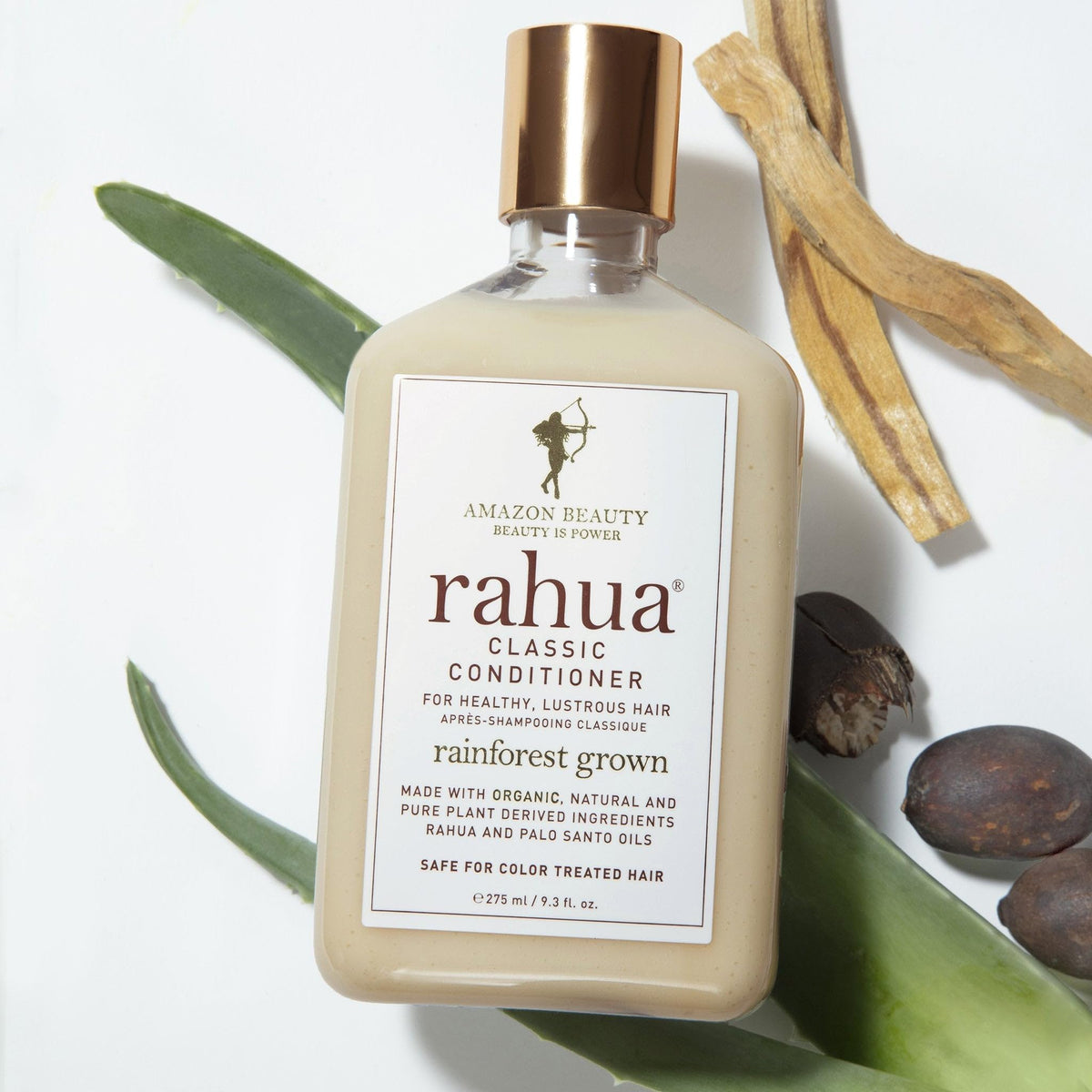 Rahua bottle beside palo santo wood indicating subtle aromatic finish