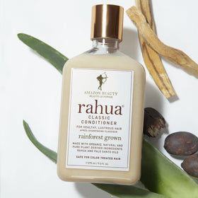 Rahua bottle beside palo santo wood indicating subtle aromatic finish