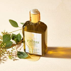 Rahua bottle beside lemongrass and eucalyptus showing natural botanicals