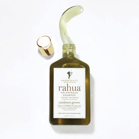 Rahua shampoo on bath shelf styling suggesting spa-like routine