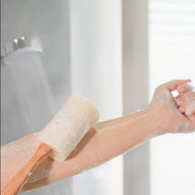 Rainlily Wen sponge held in hand to show scale and ergonomic handle advantage
