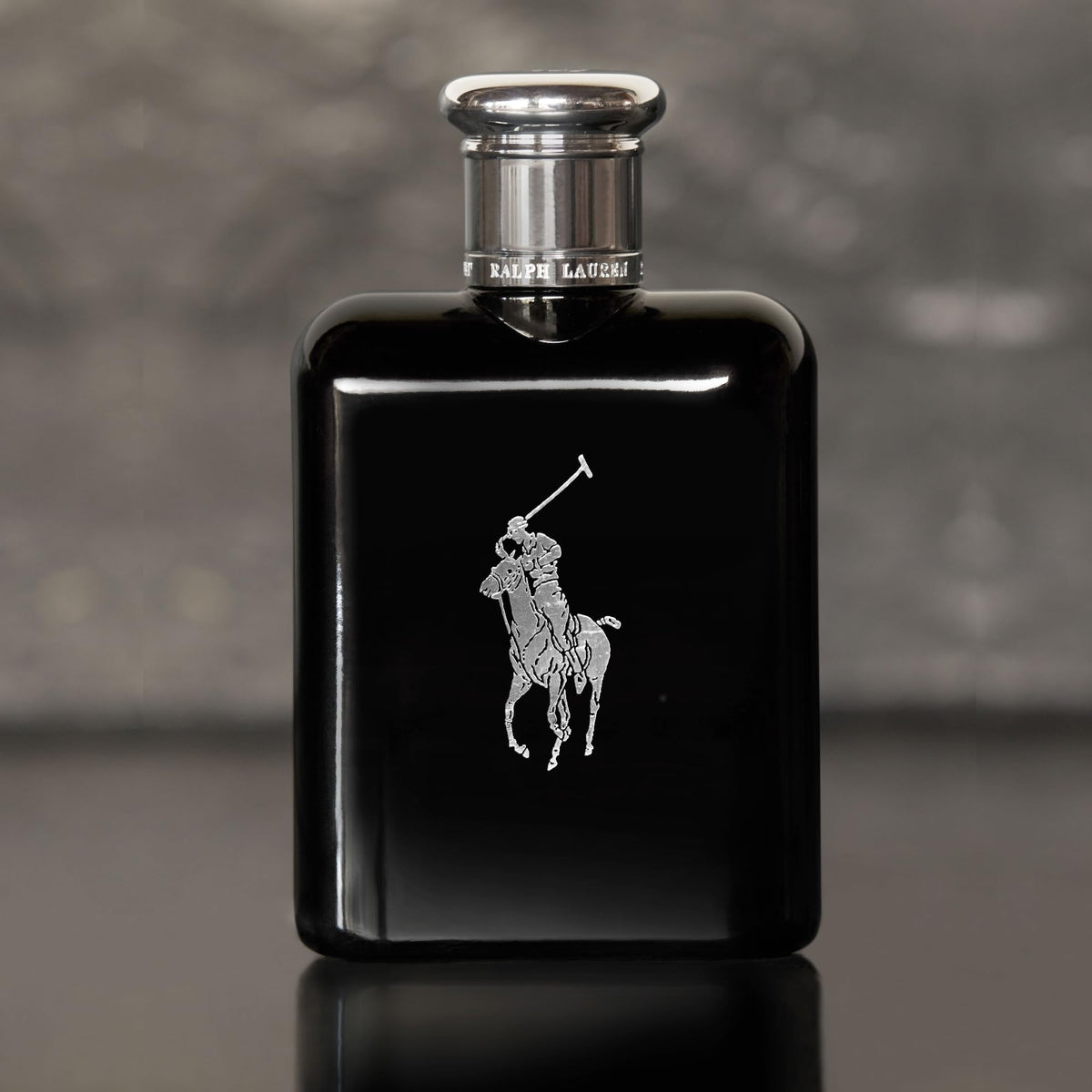 RALPH LAUREN bottle in hand illustrating 4.2 fl oz scale for travel convenience