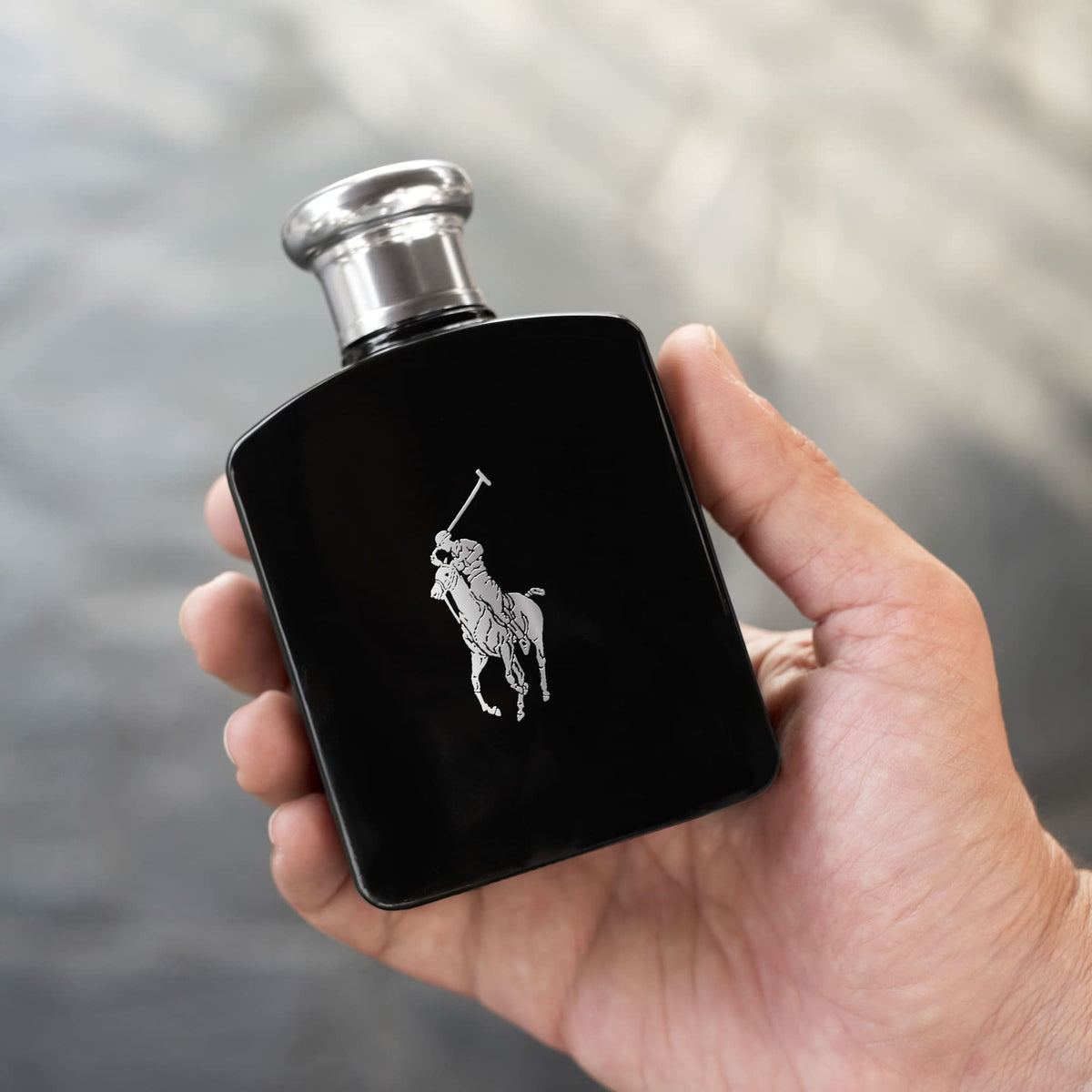RALPH LAUREN bottle being sprayed on wrist demonstrating lasting application