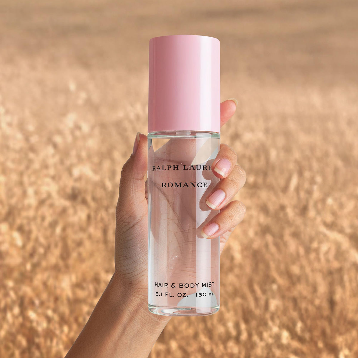 Ralph Lauren mist applied to hair demonstrating lightweight fragrance boost