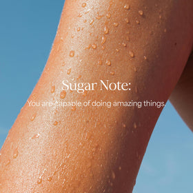 RAW SUGAR lifestyle scene in bathroom with tropical props conveying uplifting fragrance benefit