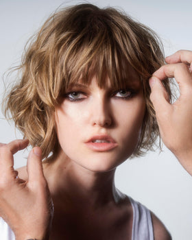 R+Co SUN CATCHER being applied to hair to protect and refresh style instantly