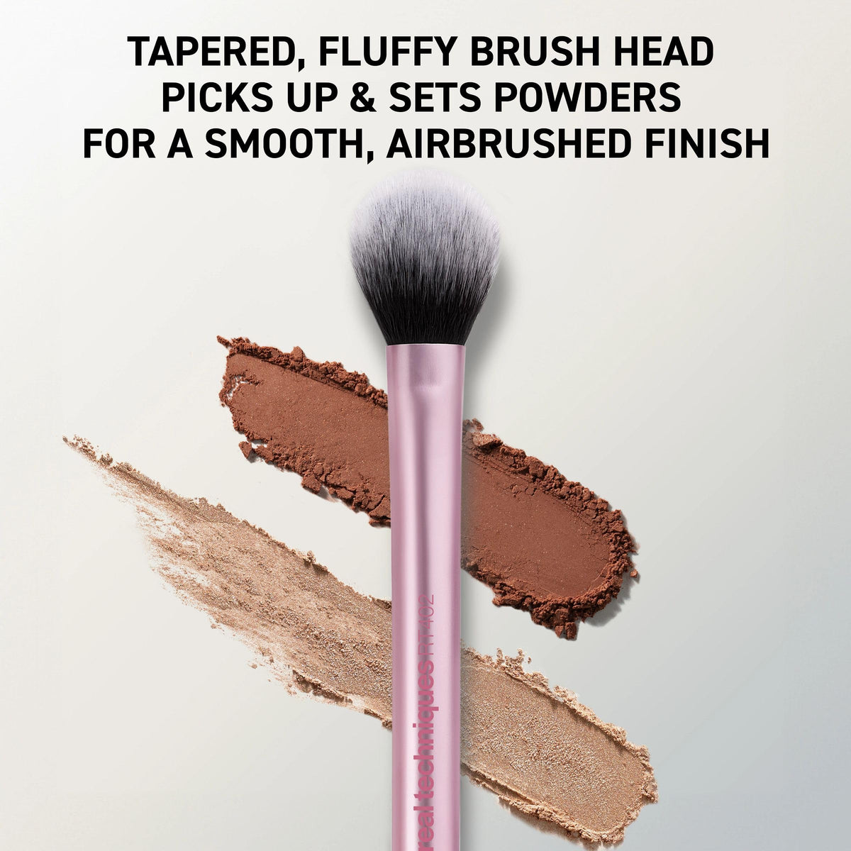 Real Techniques brush applying powder under eye to set concealer and reduce shine for longevity