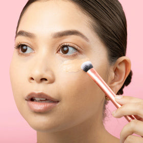 Real Techniques brush blending concealer under eye to brighten
