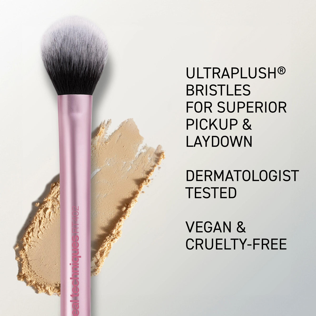 Real Techniques brush held in hand for scale to show compact size and travel-friendly design