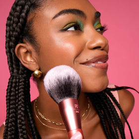 Real Techniques brush with powder product shot highlights multipurpose use for powders