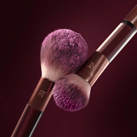 Real Techniques dual-ended brush held in hand demonstrating compact convenience