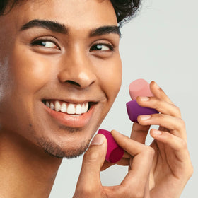 Real Techniques mini sponge in a travel pouch for on‑the‑go touch‑ups and convenience