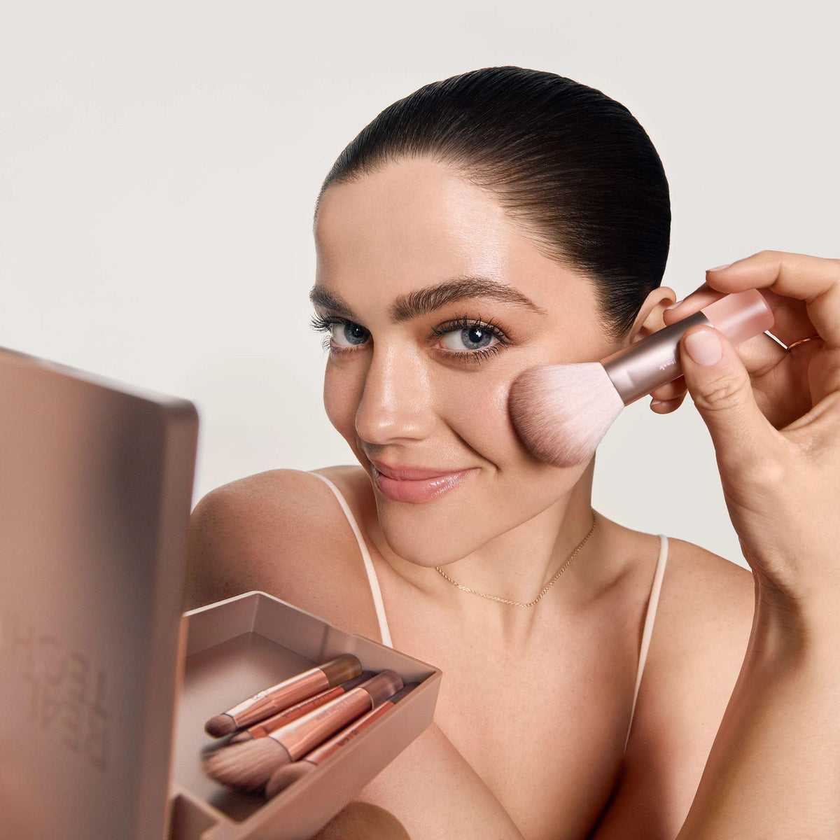 Real Techniques compact mirror open beside brushes for on-the-go precision and quick touch-ups