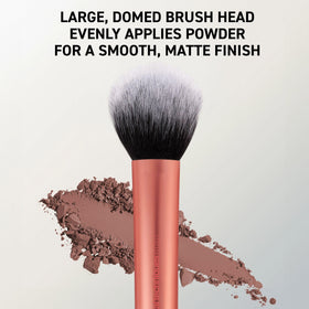 Real Techniques brush in use applying setting powder for a smooth, mattified finish