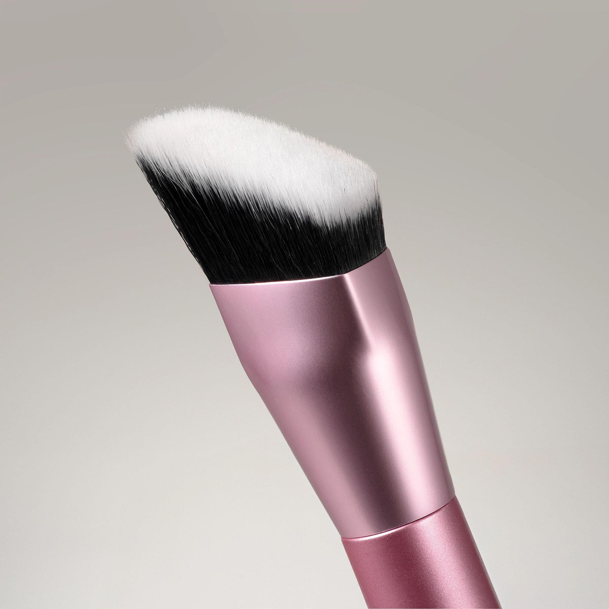 Real Techniques brush held in hand showing size and control benefit