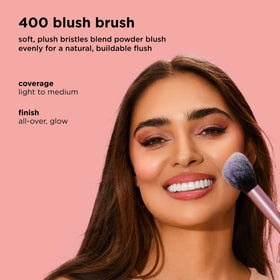 Real Techniques brush applying blush to cheek for buildable, natural rosy color