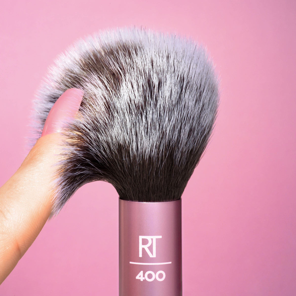 Real Techniques brush with cream blush swatch demonstrating compatibility with cream formulas