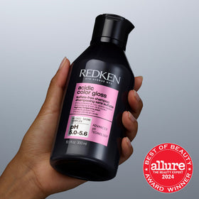 Redken bottle next to everyday items showing compact size and convenience