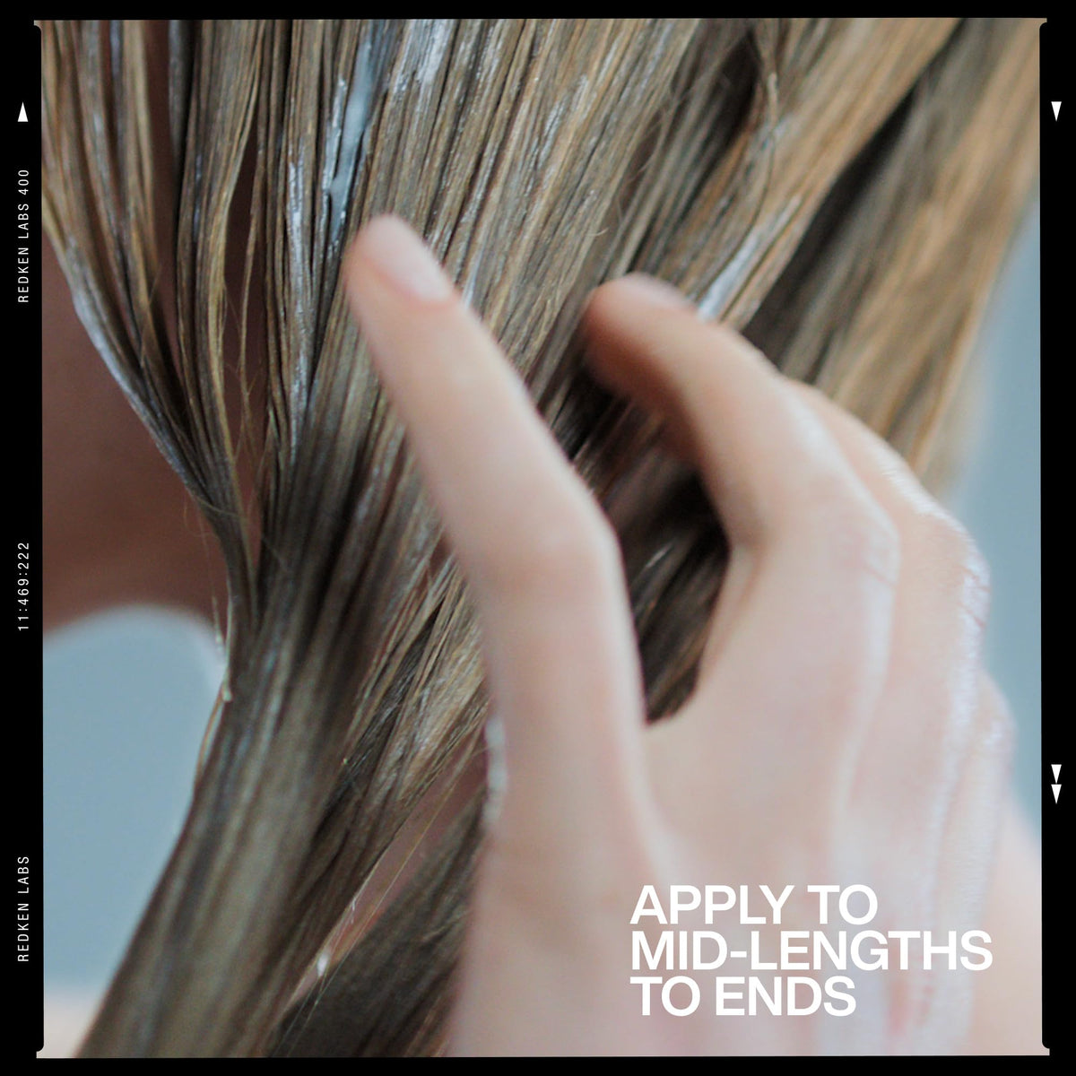 Redken conditioner placed in bathroom styling scene for routine-ready benefit