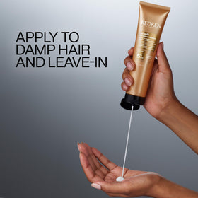 Redken bottle held in hand for scale to indicate travel-friendly size
