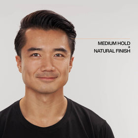 Redken Brews cream texture on open jar highlighting smooth, water-based formula