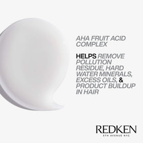 Redken bottle on bathroom shelf suggesting routine use and shiny hair results