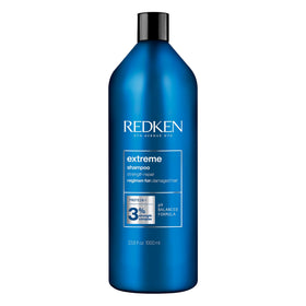 Redken bottle front view showing branding and repair benefits