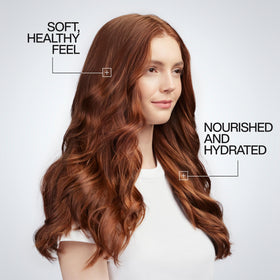 Redken lifestyle model with sleek hair demonstrating anti-frizz and polished finish
