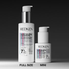 Redken bottle in hand illustrating 1.6 fl oz size for scale and travel-ready benefit