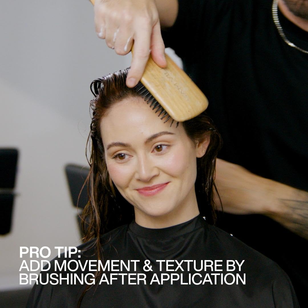 Redken product label close-up highlighting protein and hold benefits