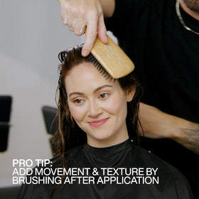 Redken product label close-up highlighting protein and hold benefits