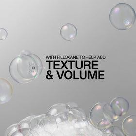 Redken shampoo lather texture on hair demonstrating lightweight foaming action