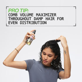 Applying Redken Volume Maximizer to damp hair for root lift and body