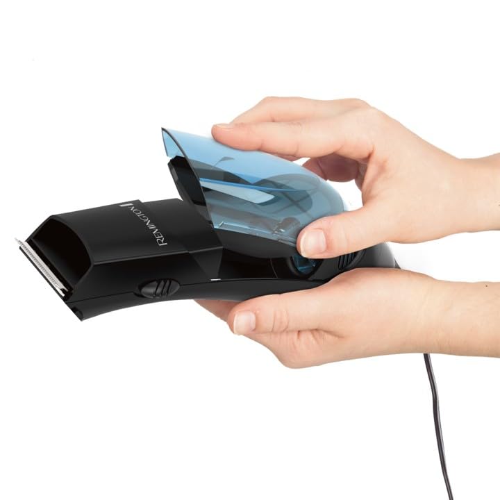 Remington clippers in use during self-haircut capturing trimmed hair for convenience