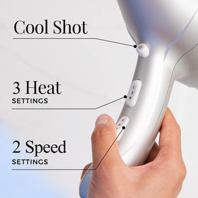 Person using Remington dryer to style hair for salon-like shine at home