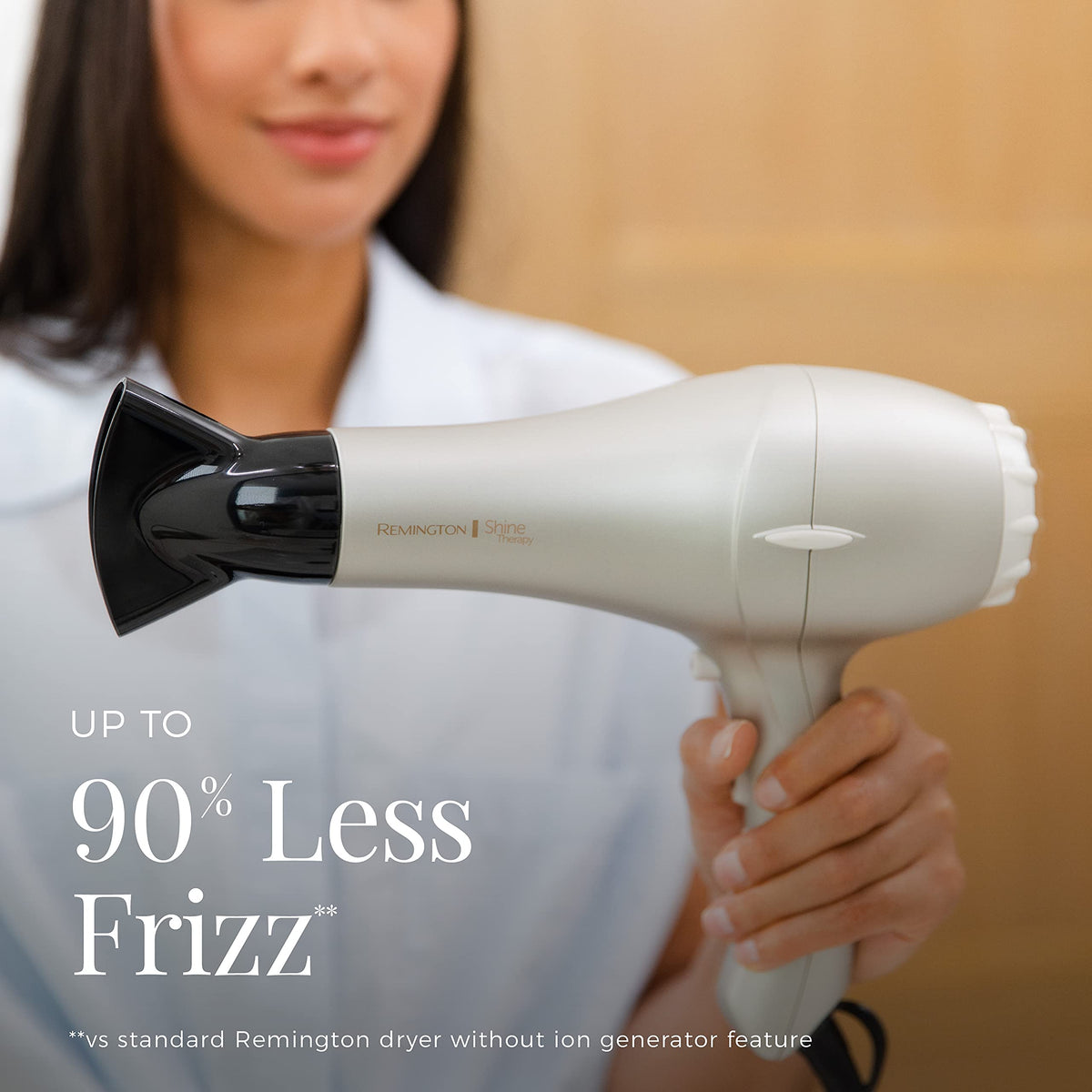 Hand holding Remington dryer to show lightweight size and comfortable grip