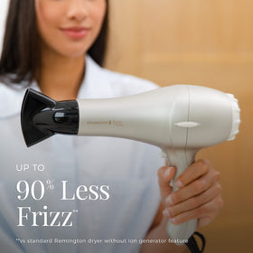 Hand holding Remington dryer to show lightweight size and comfortable grip