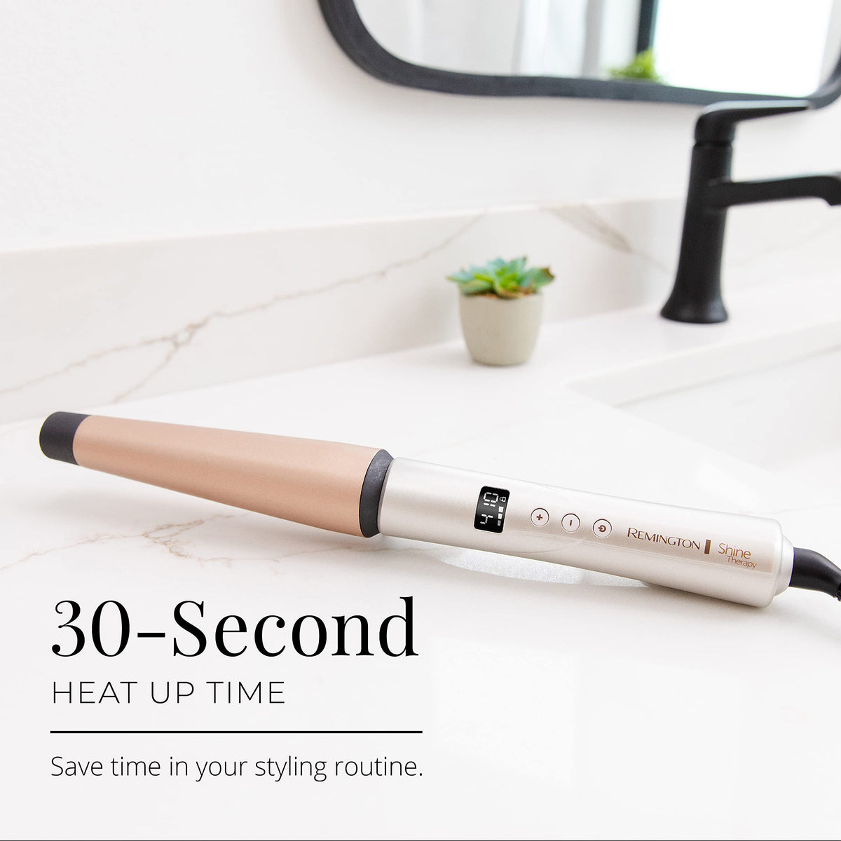 Remington wand beside hand to show 11.25 inch length and ergonomic scale