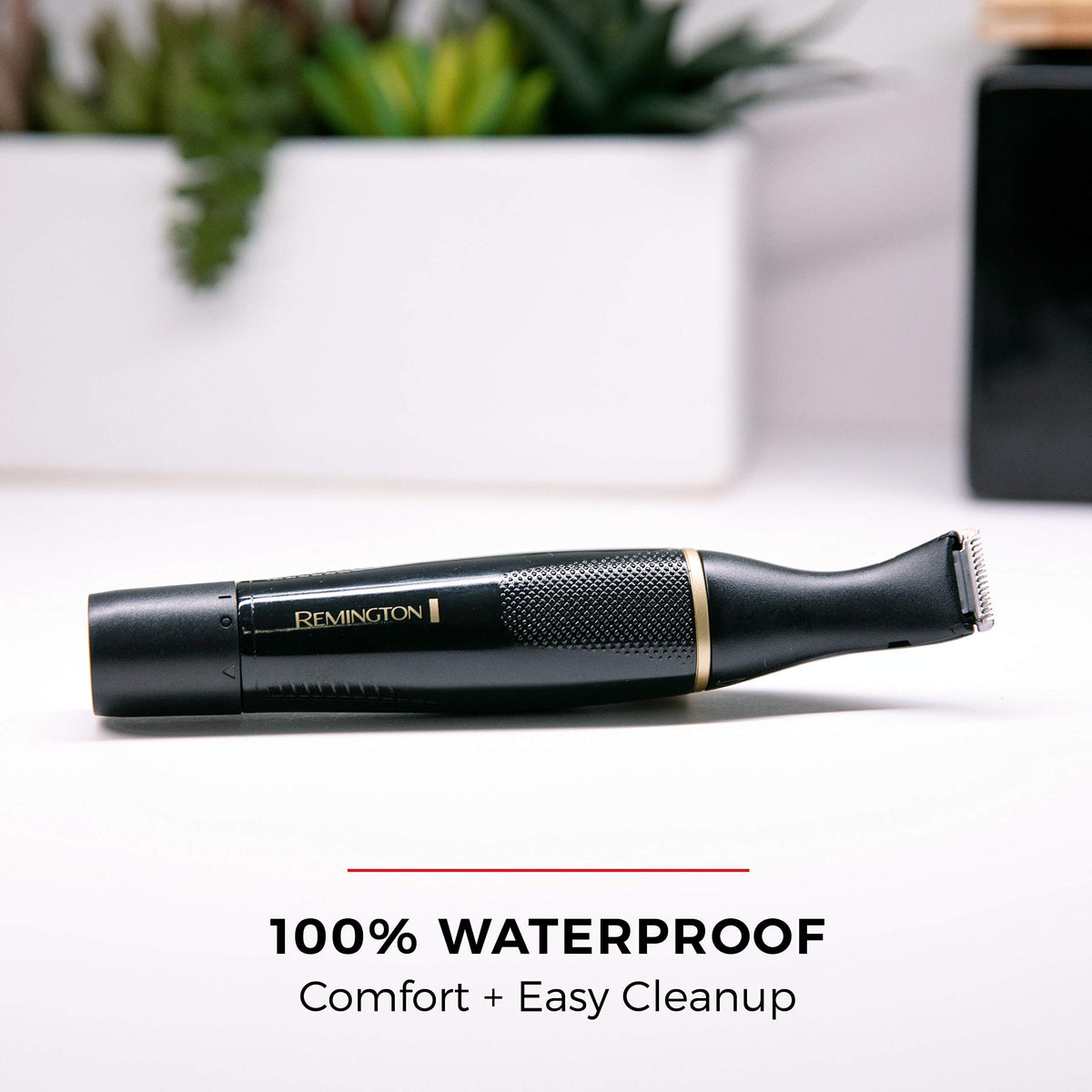 Remington trimmer under running water illustrating waterproof design for easy cleaning