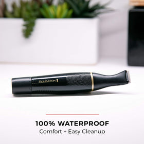 Remington trimmer under running water illustrating waterproof design for easy cleaning