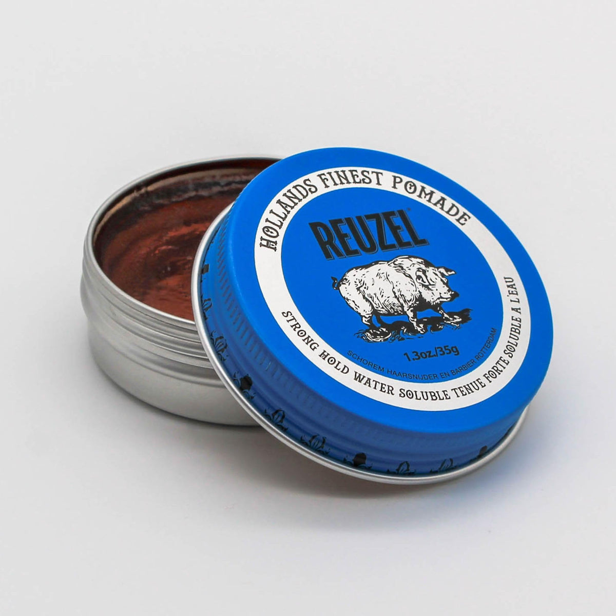 REUZEL Blue Pomade in hand close-up texture demonstrating smooth, pliable hold