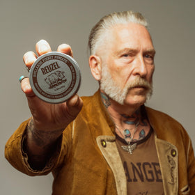 REUZEL rinsing pomade under water to show easy washout and no buildup