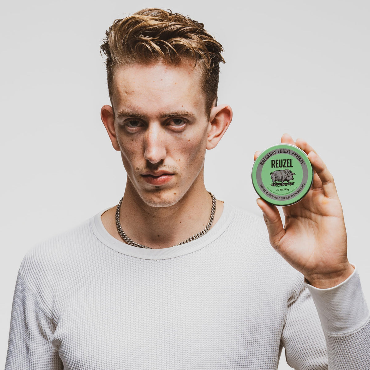 REUZEL on bathroom counter in lifestyle scene suggesting everyday grooming benefit