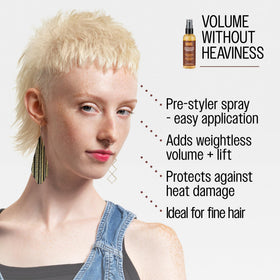 Reuzel mist being applied during blow-dry to add lift and protect hair