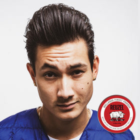 REUZEL Red pomade held in hand to show size and travel-friendly convenience