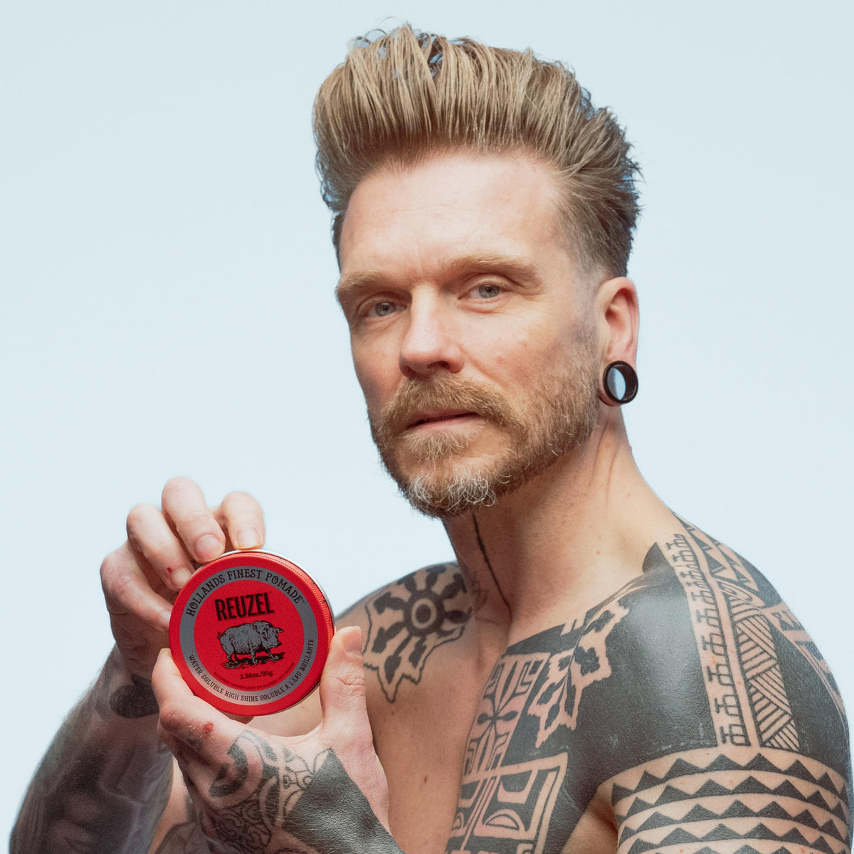 Wet hair being rinsed to show REUZEL Red pomade washes out easily with water