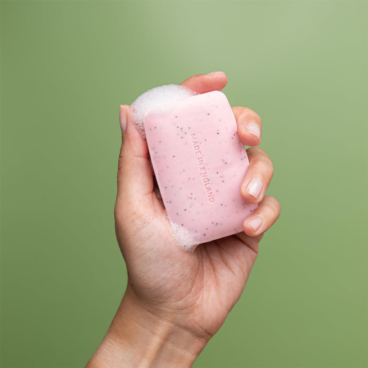 REVITALE soap held in hand to show compact size and easy application