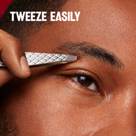 Revlon tweezers size comparison beside a coin to show portable grooming convenience